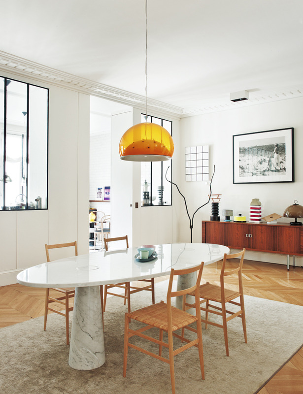 Marble dining table with wood chairs in Sandra Benhamou's Midcentury Paris Apartment