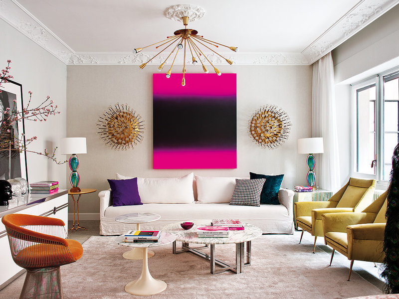 Living Pink living room with yellow side chairs and pink art