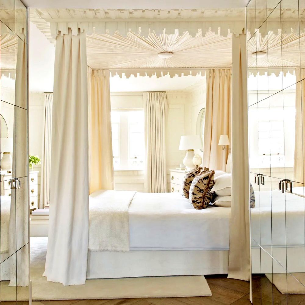 Traditional canopy bed hung with silk curtains 