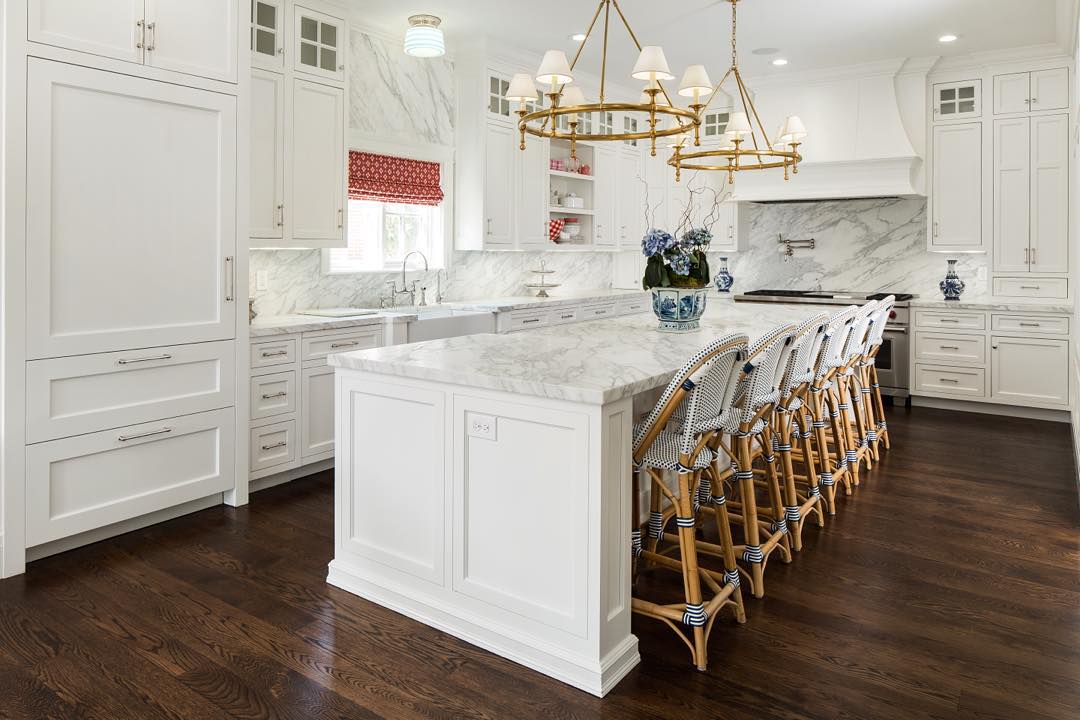 Fox Group designed this lovely white marble kitchen with plenty of French bistro style bar stools