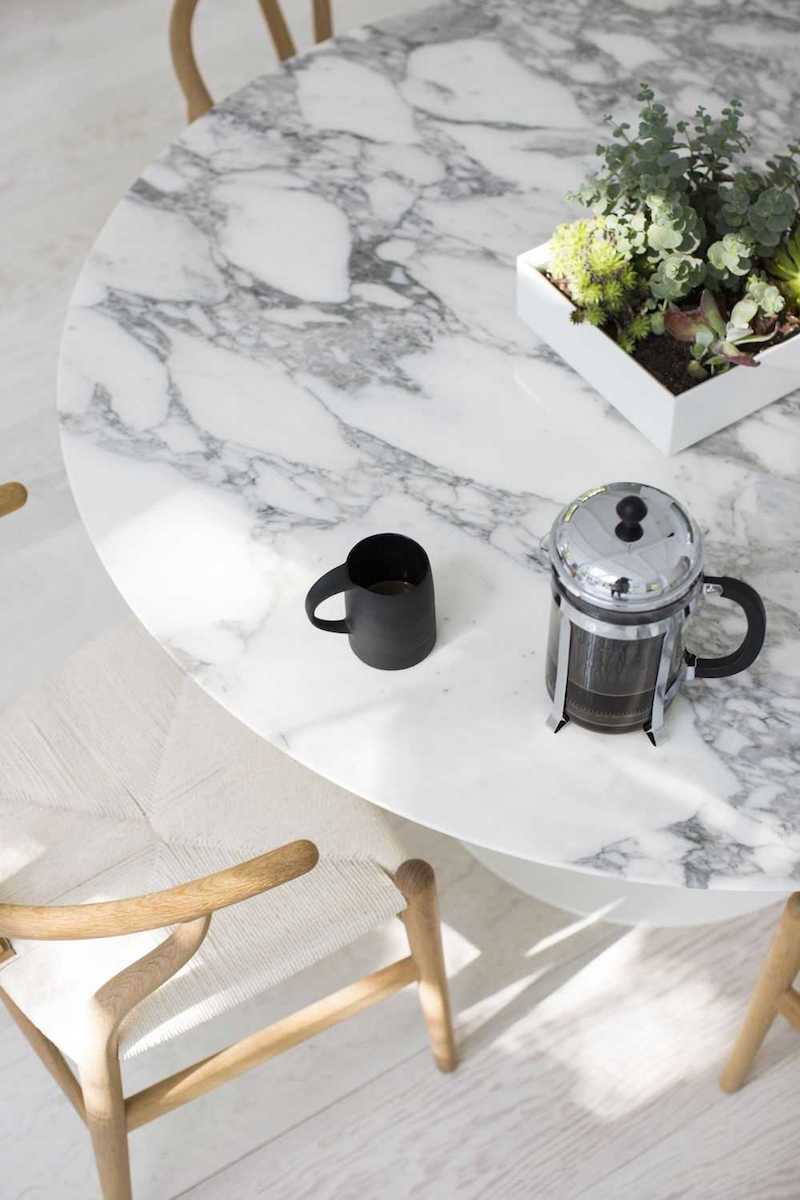 White Marble Dining Table with wishbone chairs and french press