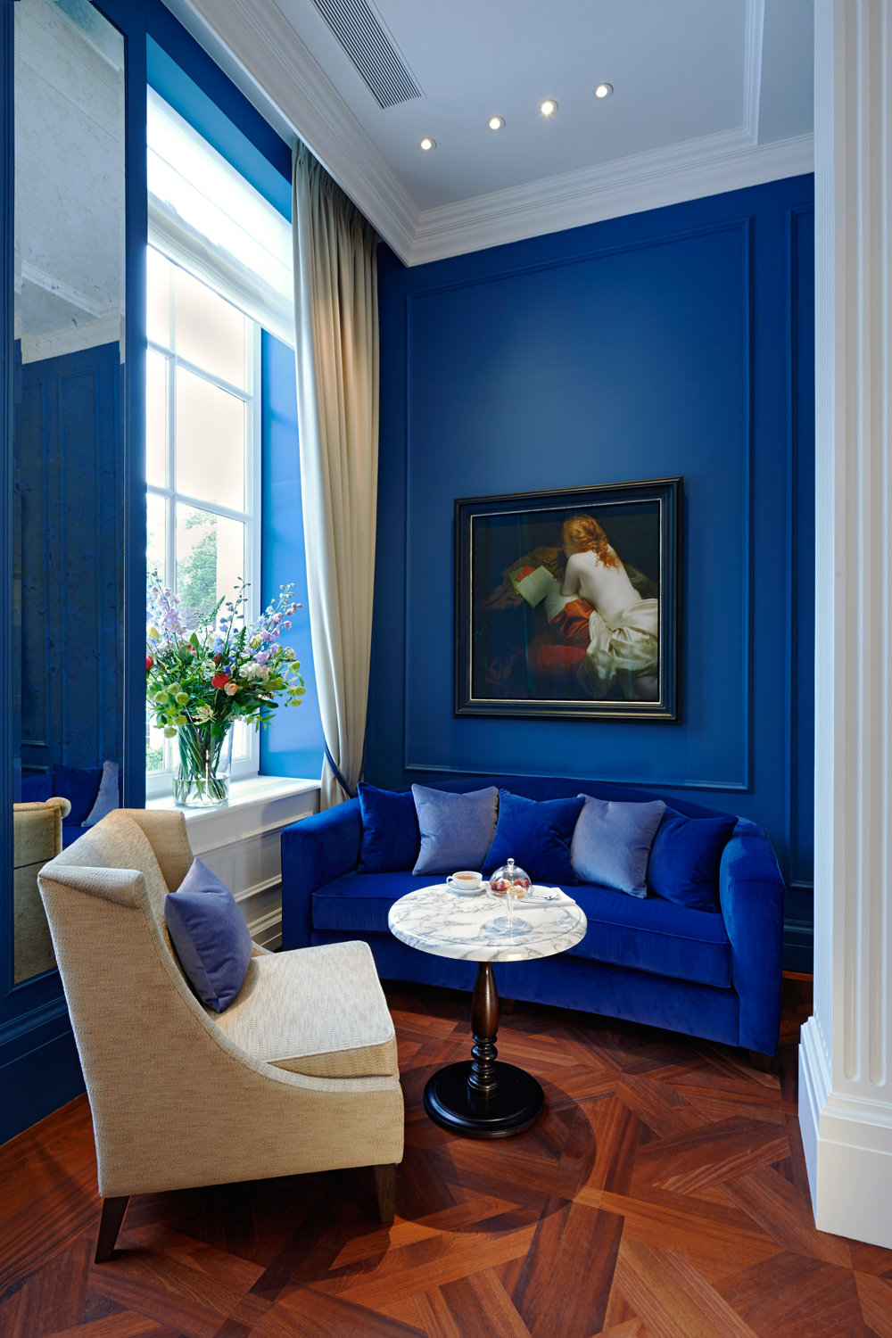 Blue Velvet Sofa Against Blue Wall via Vogue