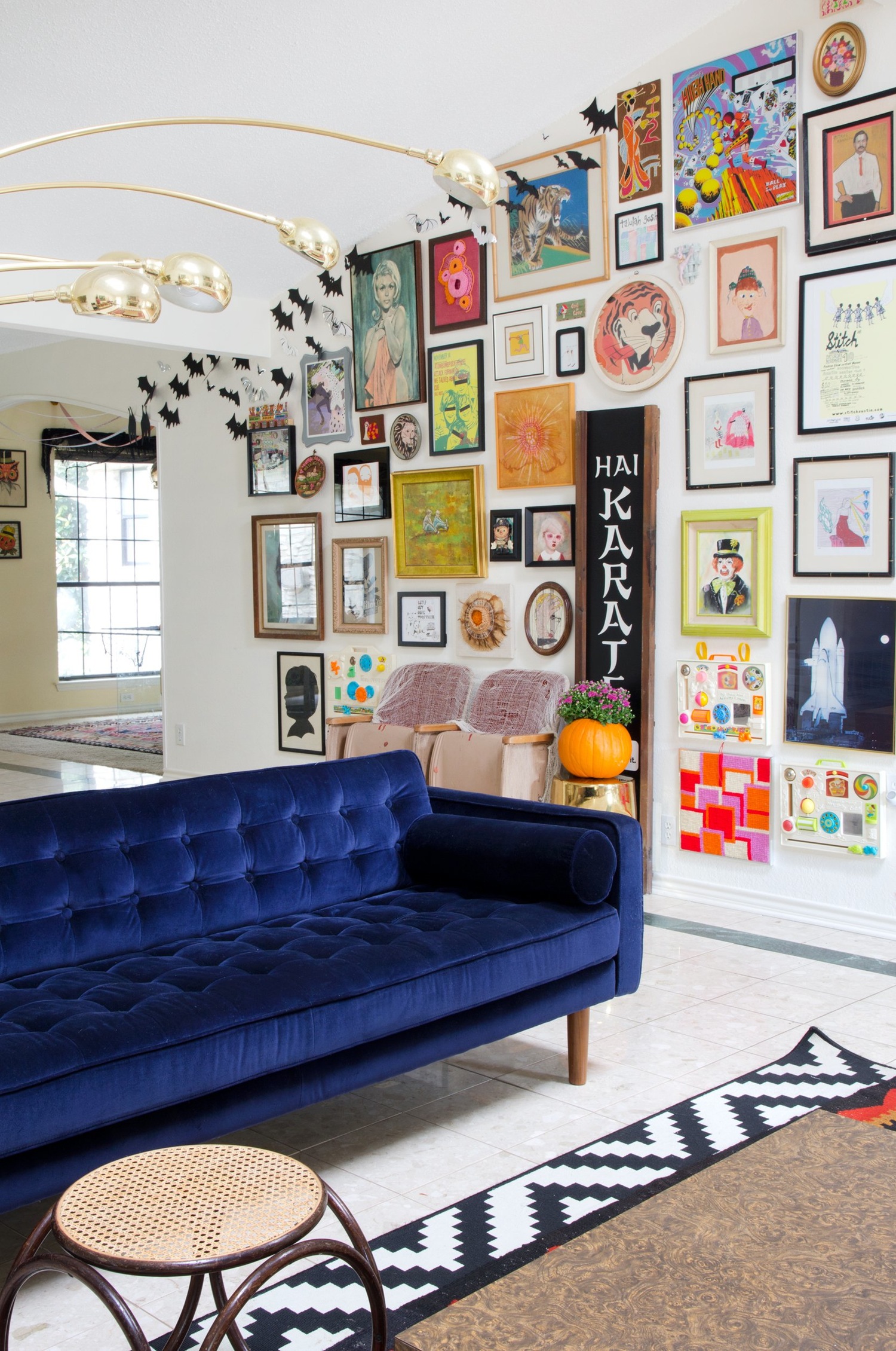 Blue Velvet Sofa with a Bright and Colorful Gallery Wall!