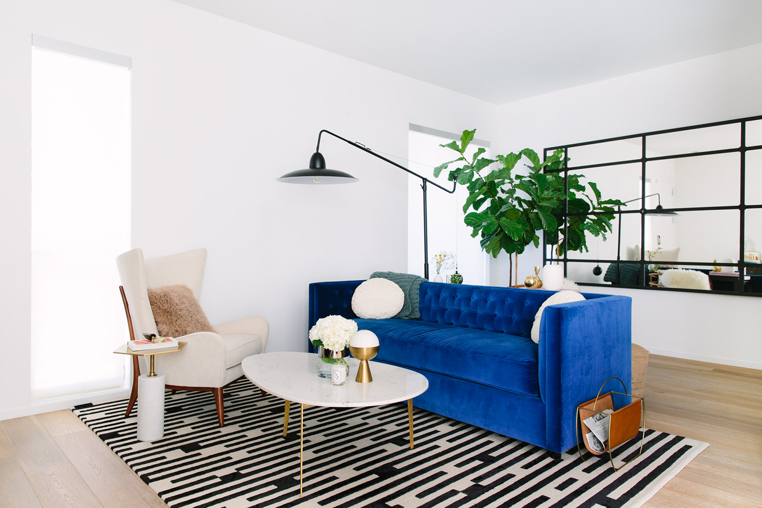 Blue Velvet Sofa with a black and white rug