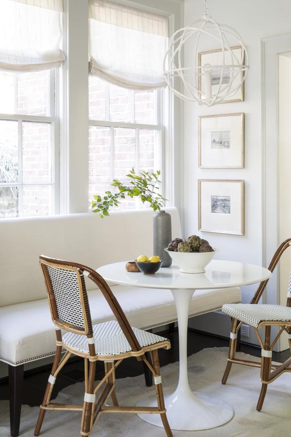 TWo French bistro chairs at white tulip table breakfast nook with bench