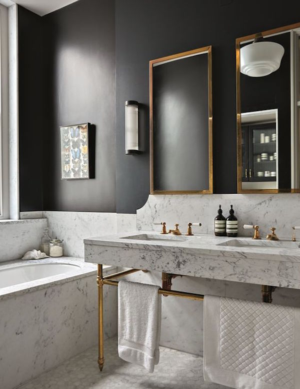 Brass Finish and Black Wall in a Marble Bathroom