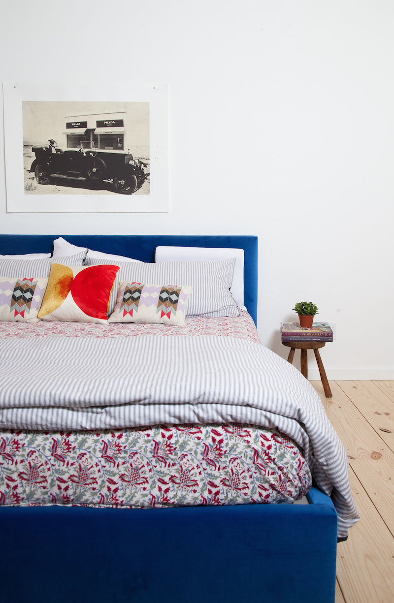 Claire Zinnecker Blue bed with Prada marfa artwork