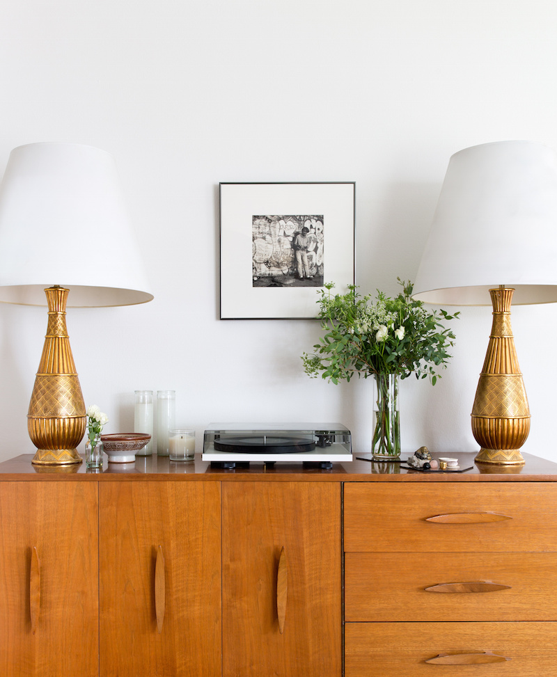 Claire Zinnecker Brown sideboard with gold lamps