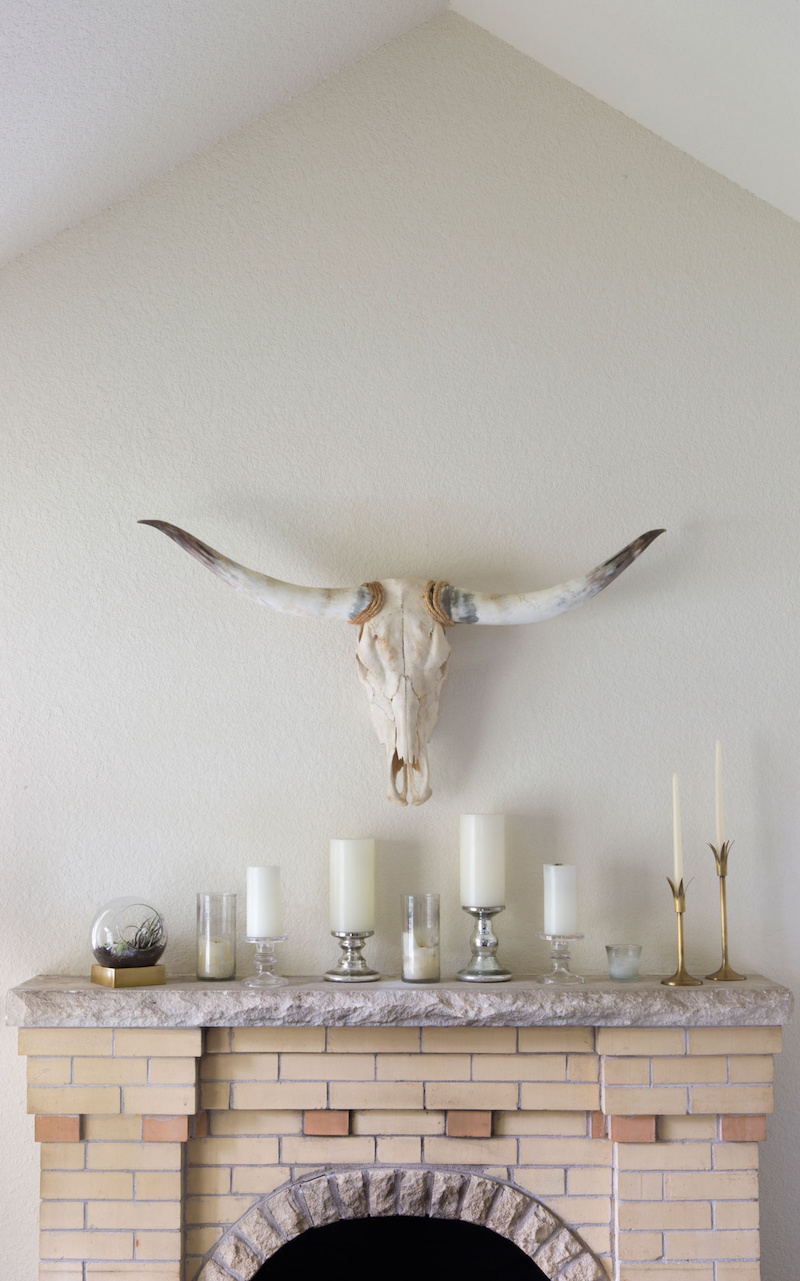 Claire Zinnecker Fireplace with white candles and bull skull taxidermy