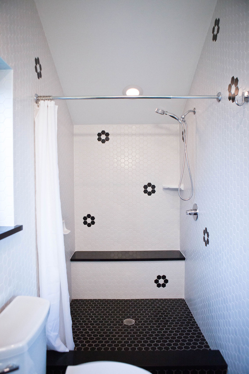 Claire Zinnecker White bathroom with black flower tiles