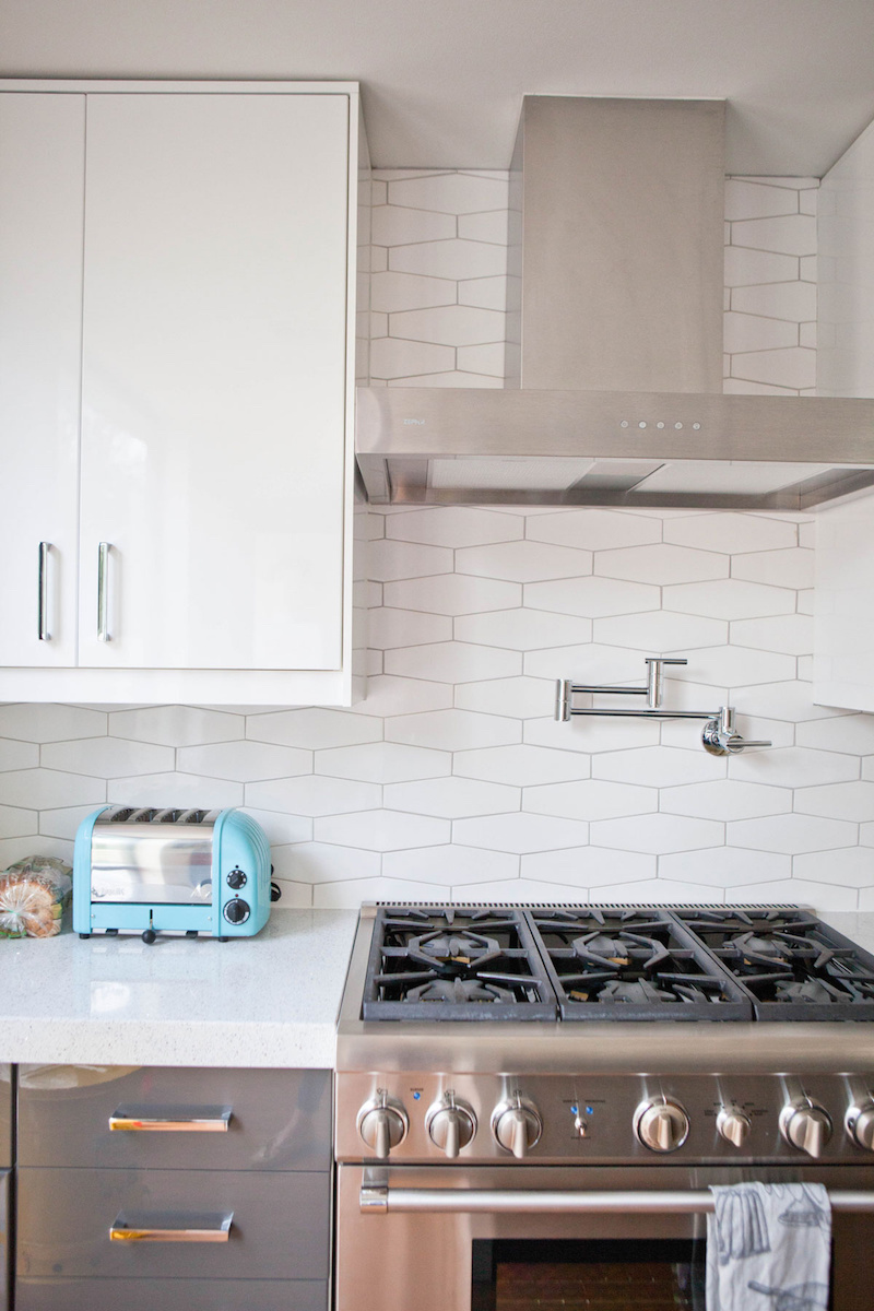 Claire Zinnecker White tile kitchen with silver stove