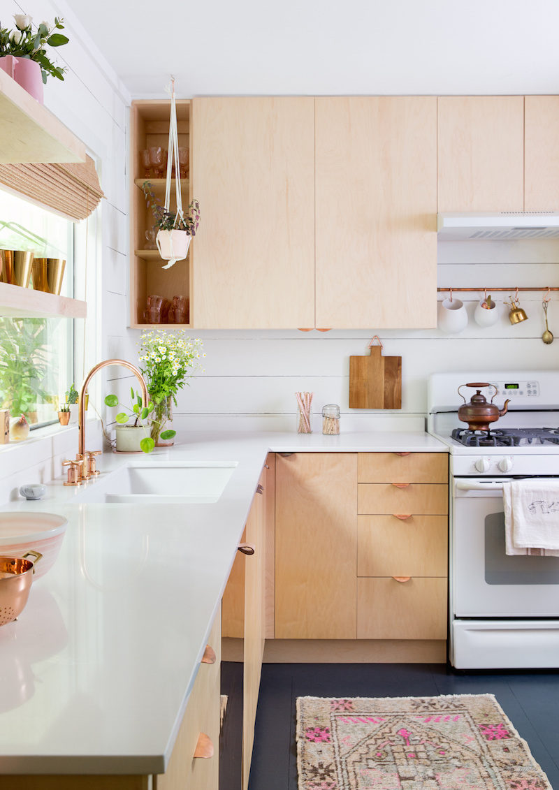 Claire Zinnecker Wood cabinet kitchen with Pink rug