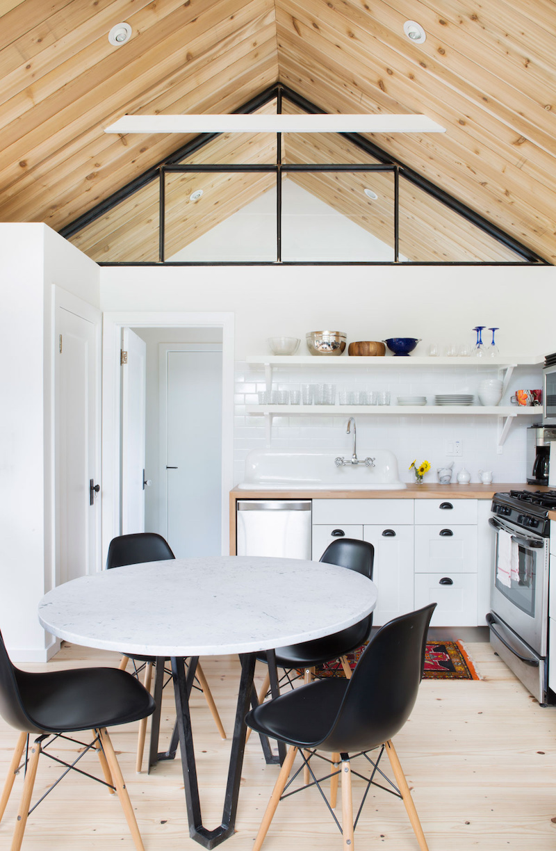 Claire Zinnecker Wooden floor kitchen nook with black chairs