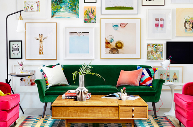 Green Velvet Sofa with Colorful Gallery Wall and Pink Chairs