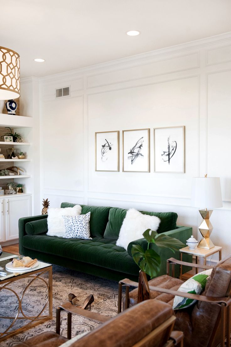 Green Velvet Sofa with White Fur Pillows and Brown Leather