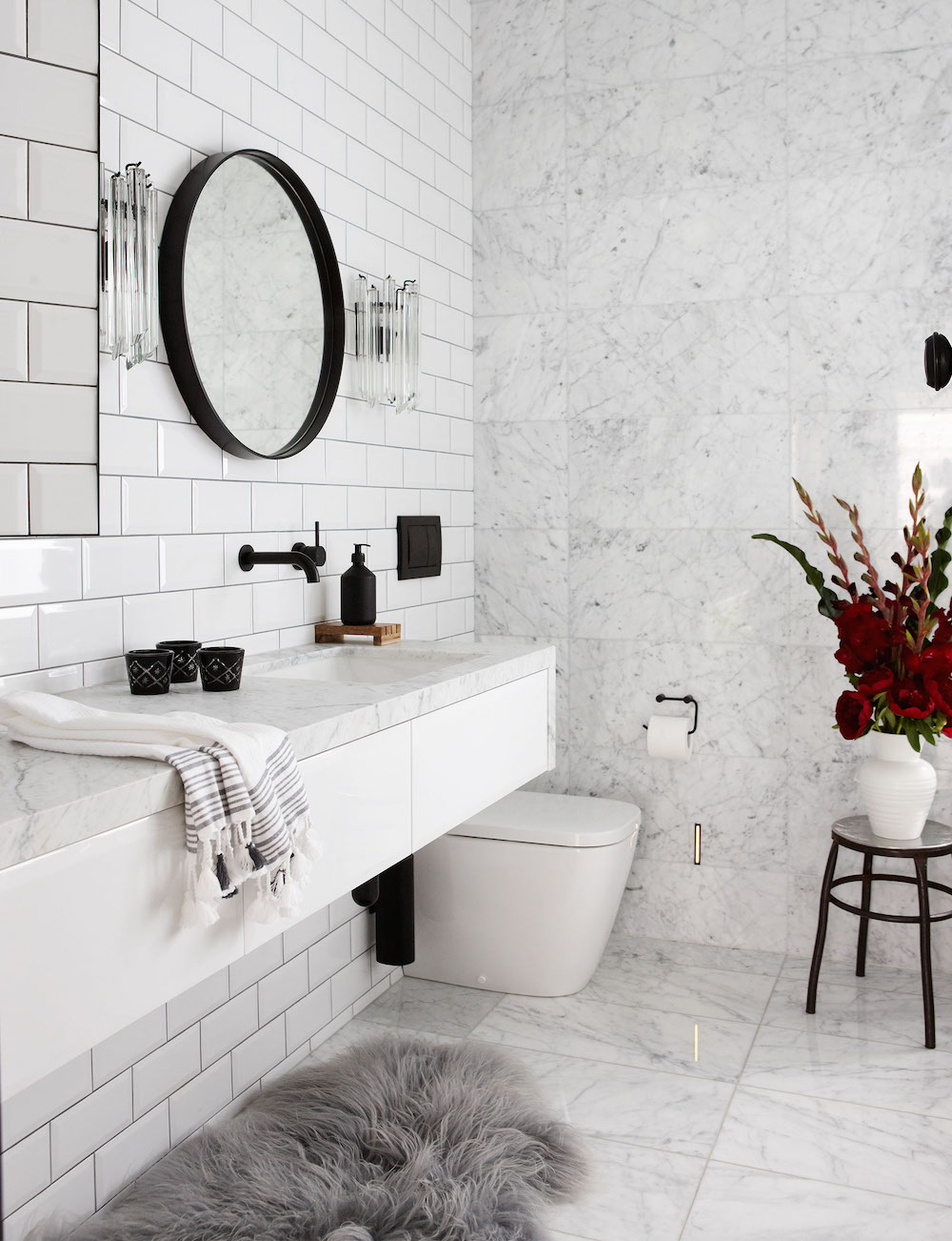 Marble Bathroom with Gray Fur Rug and Black Fixtures