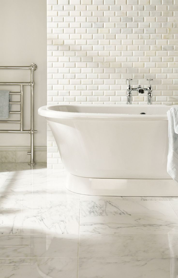 Marble Floor bathroom with tub and Subway Tiling