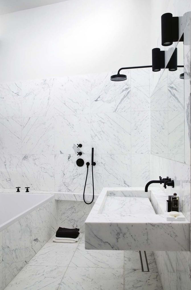 Marble bathroom with black lights and fixtures