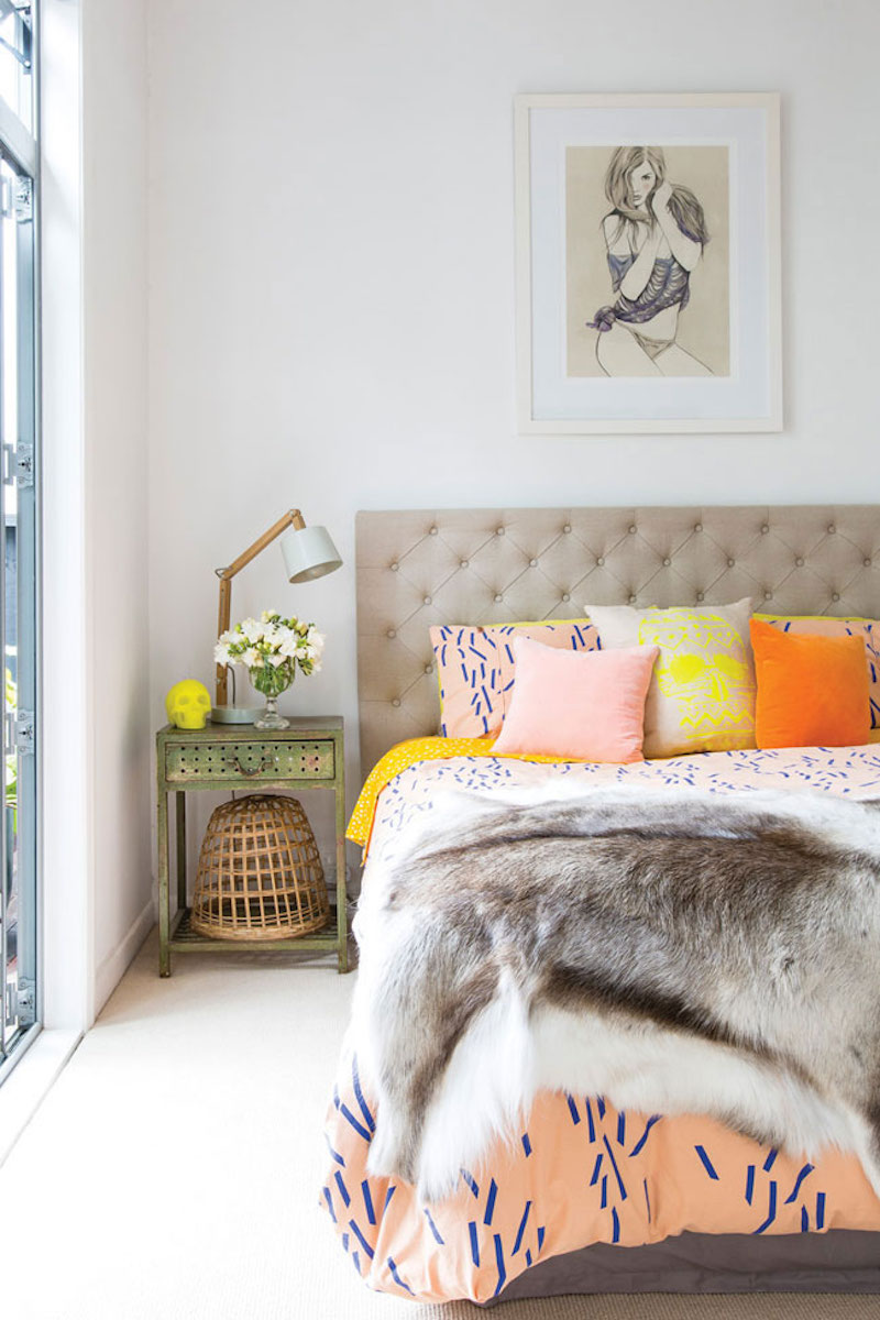 Bedroom with peach orange and yellow throw pillows