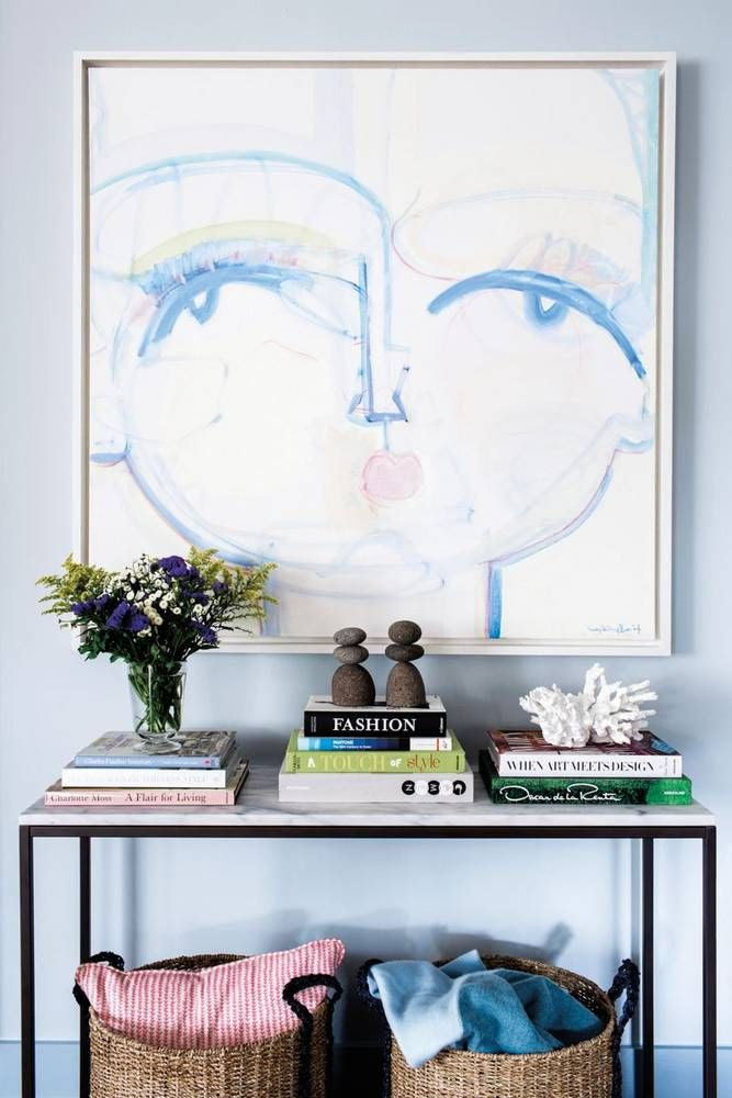 Blue face artwork by Sally King Benedict in a chic Entryway