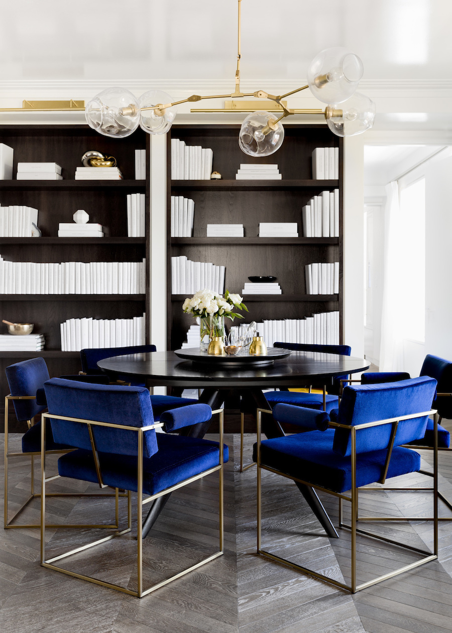 Dining room with black table and blue velvet chairs