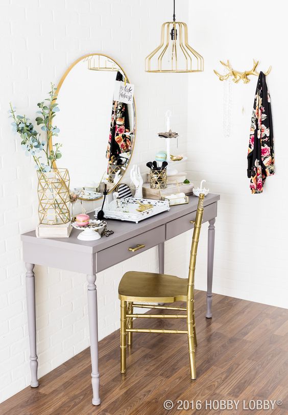 Grey vanity with gold mirror and chair