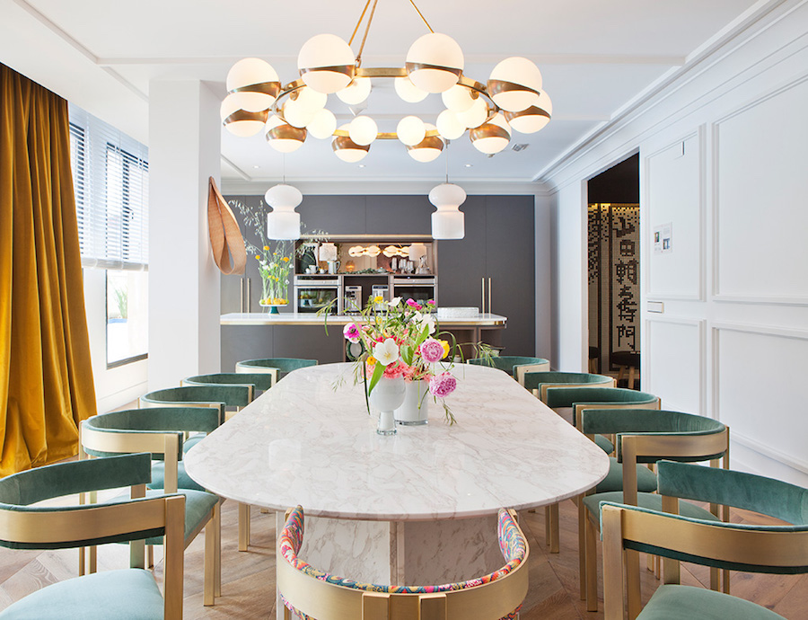 Large marble dining room table with soft blue velvet chairs