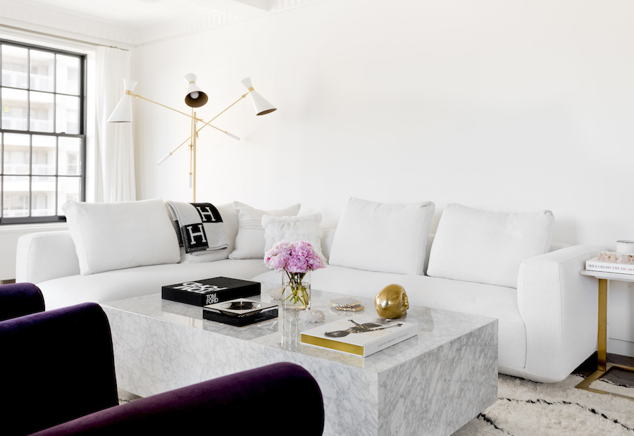 Living room with white sofa and marble block coffee table