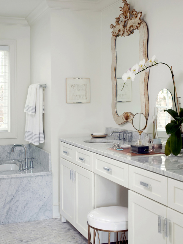 Marble bathroom vanity with ornate mirror