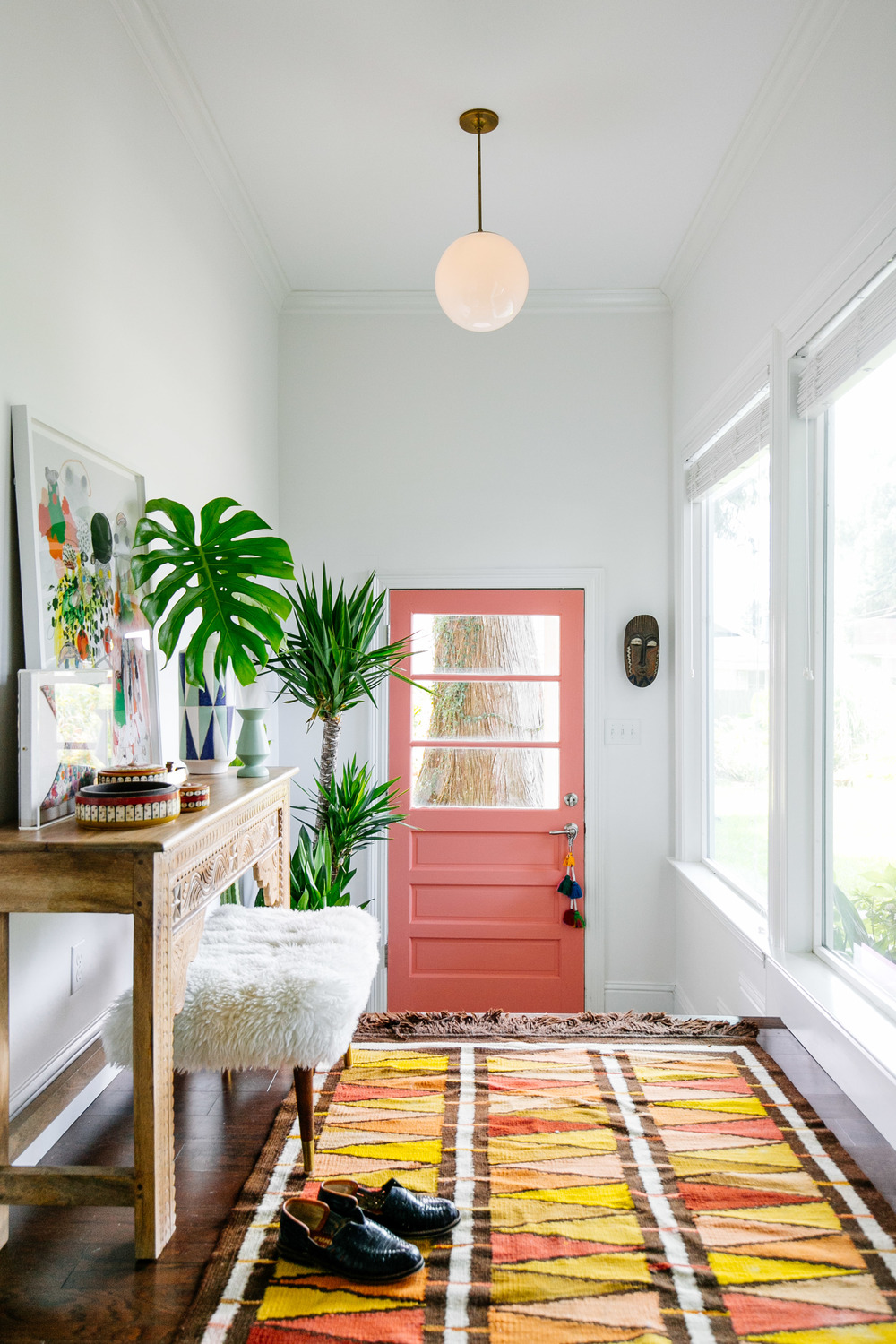 Peach door with orange rug Entryway via Old Brand New