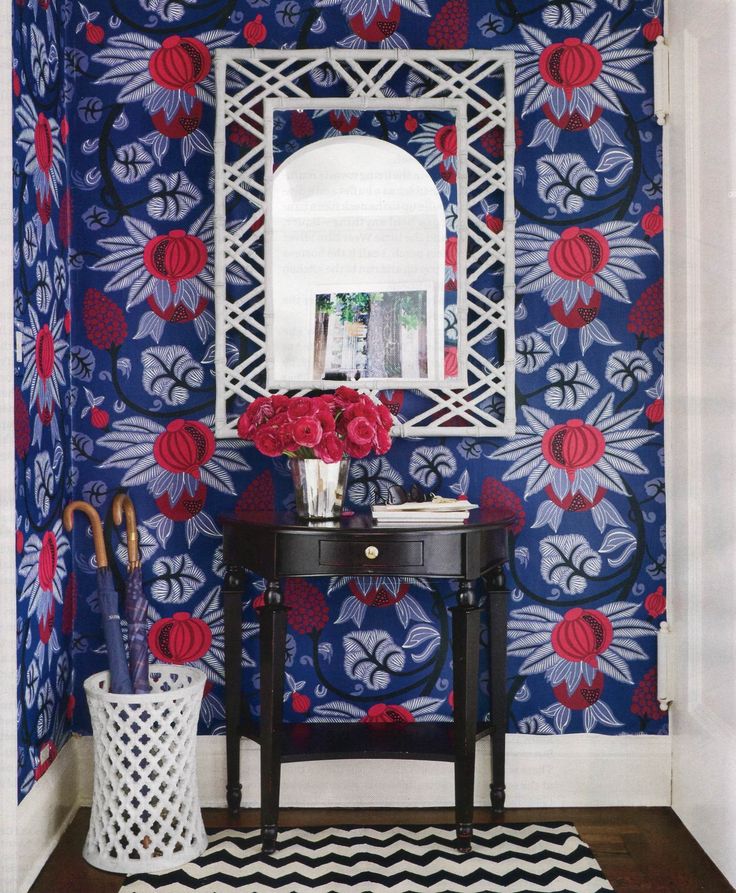 Red and blue wallpaper with black sidetable Entryway