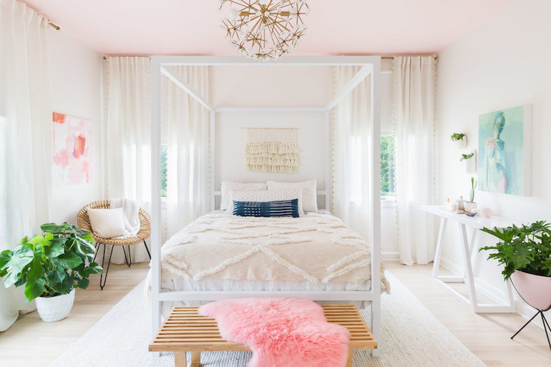 White canopy bed in room with pink ceiling by Alyssa Rosenheck