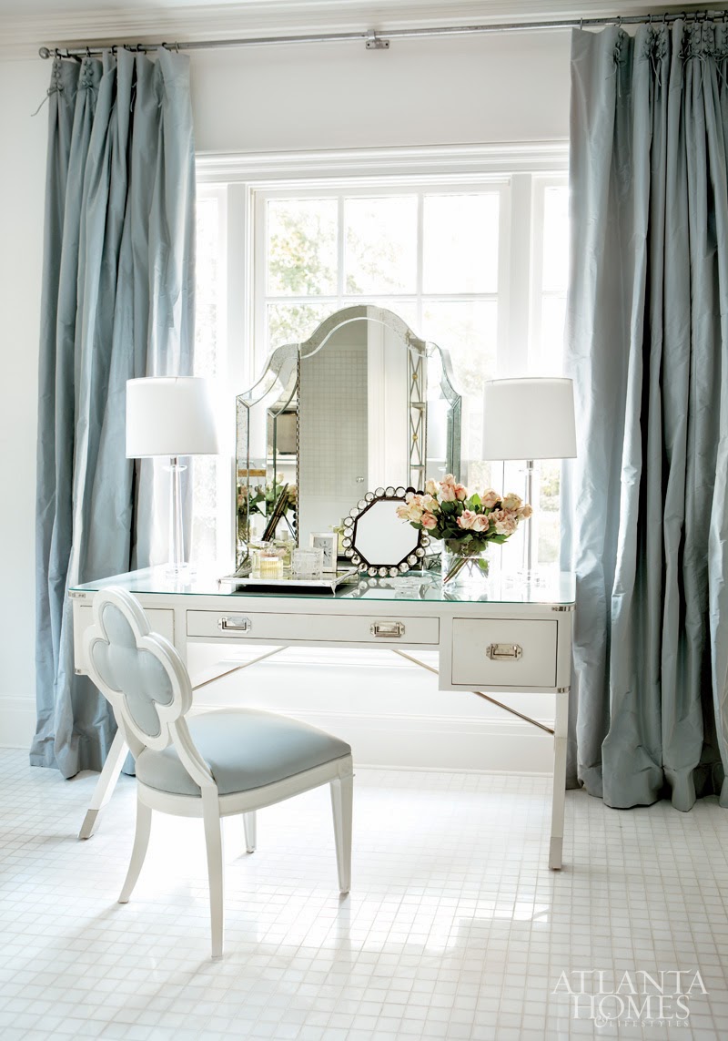 White vanity with blue chair and curtains via Atlanta Homes