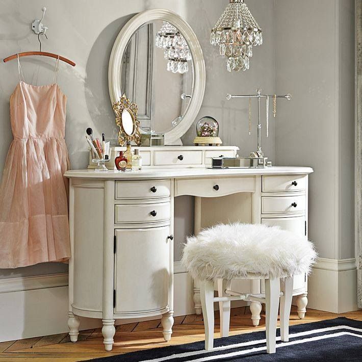 White vanity with fur stool and crystal chandelier