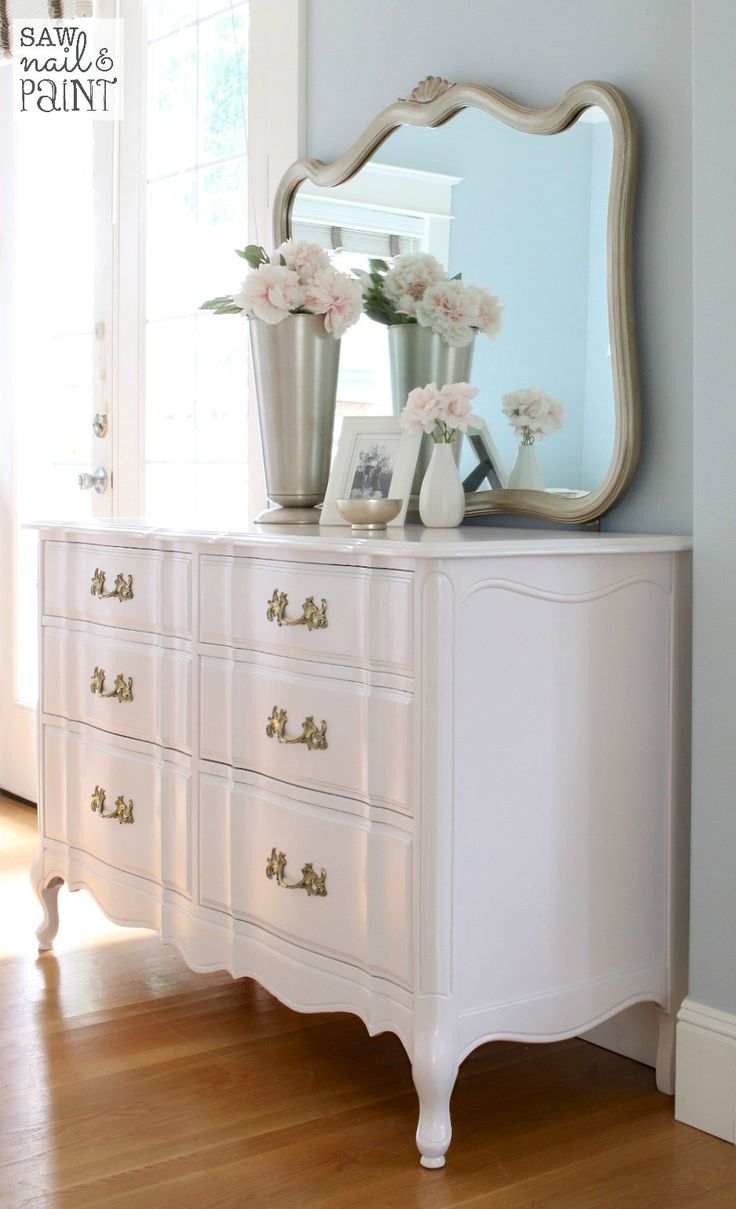 White vintage dresser with flowers and mirror