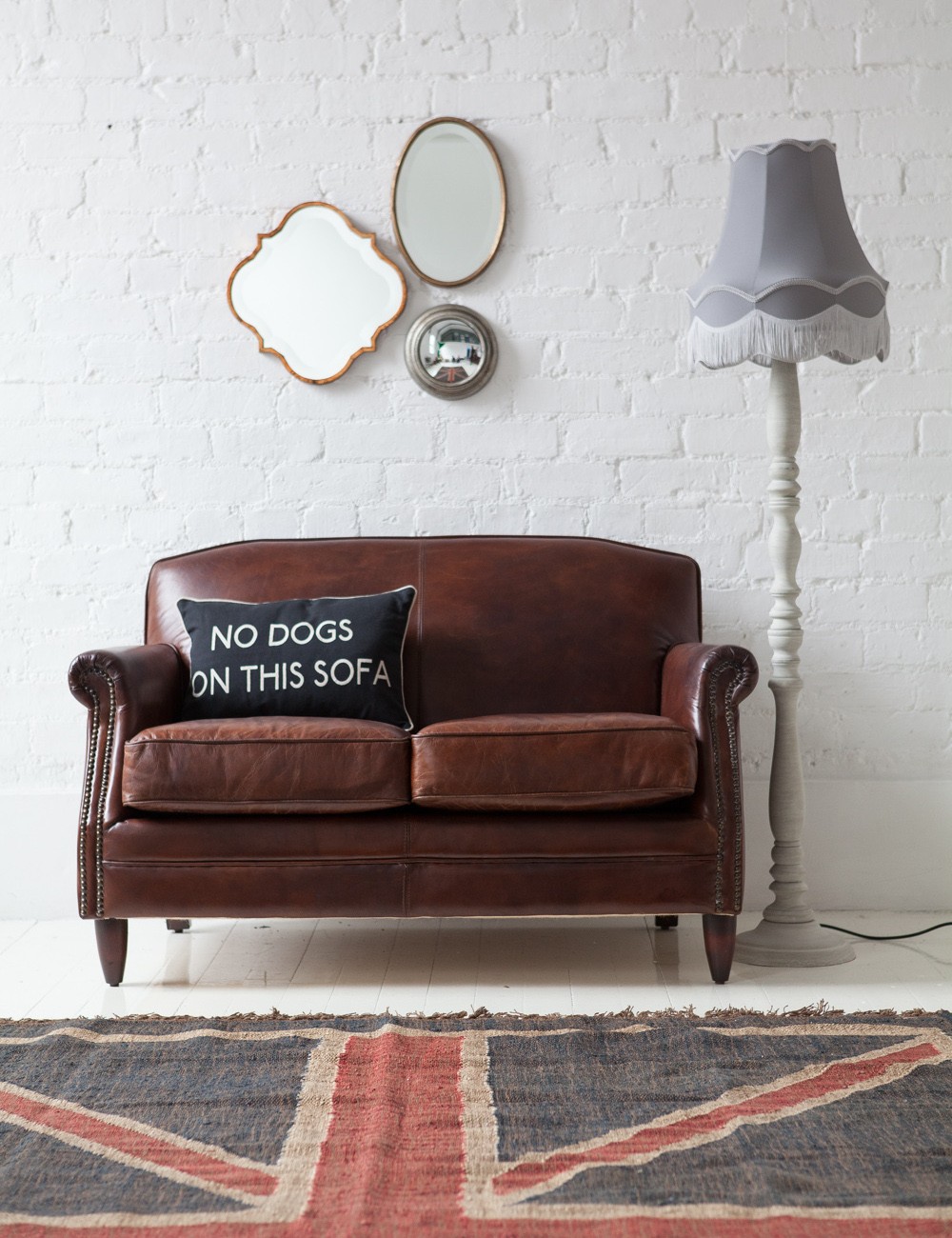 Brown leather sofa with UK rug