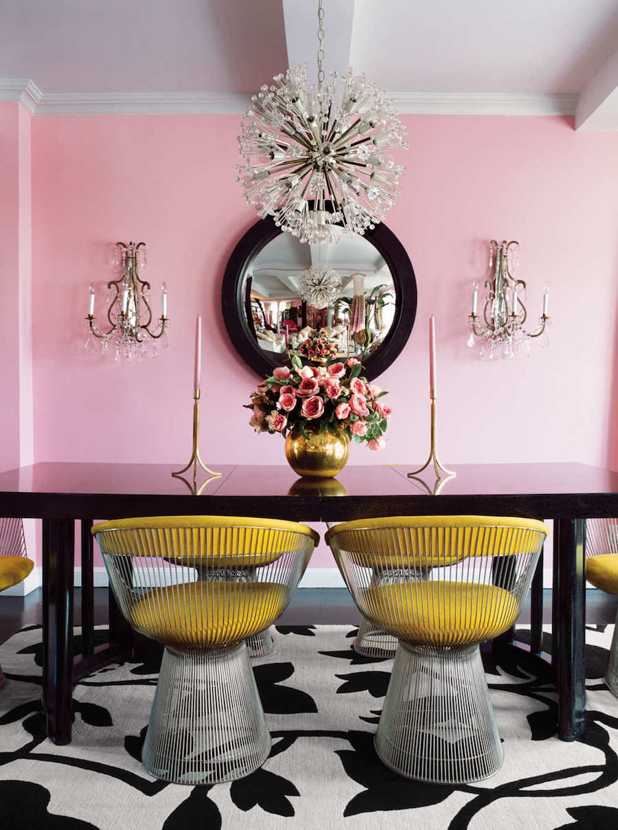 Dining room with pink walls and yellow chairs via elle decoration uk