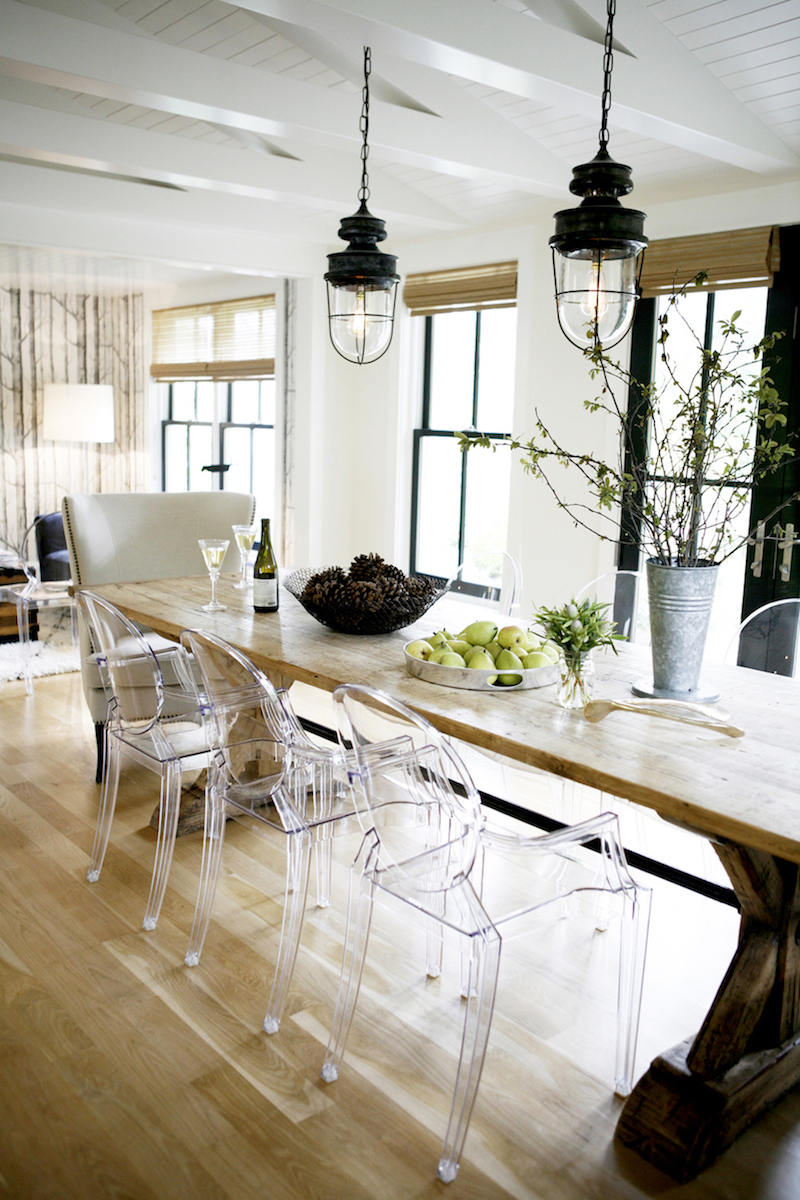 Ghost chairs at rustic wood dining table