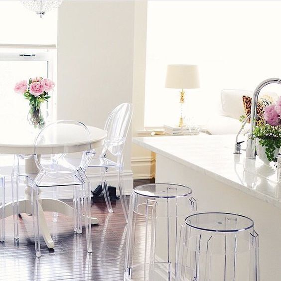 Ghost chairs around white table