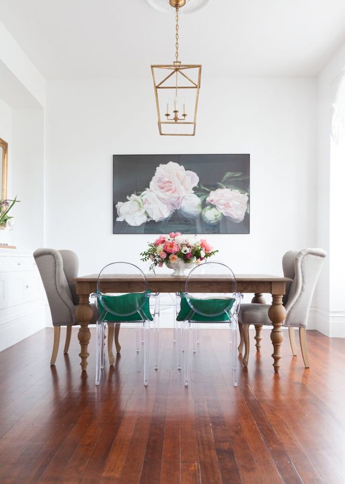 Ghost chairs with green cushions at wood dining table