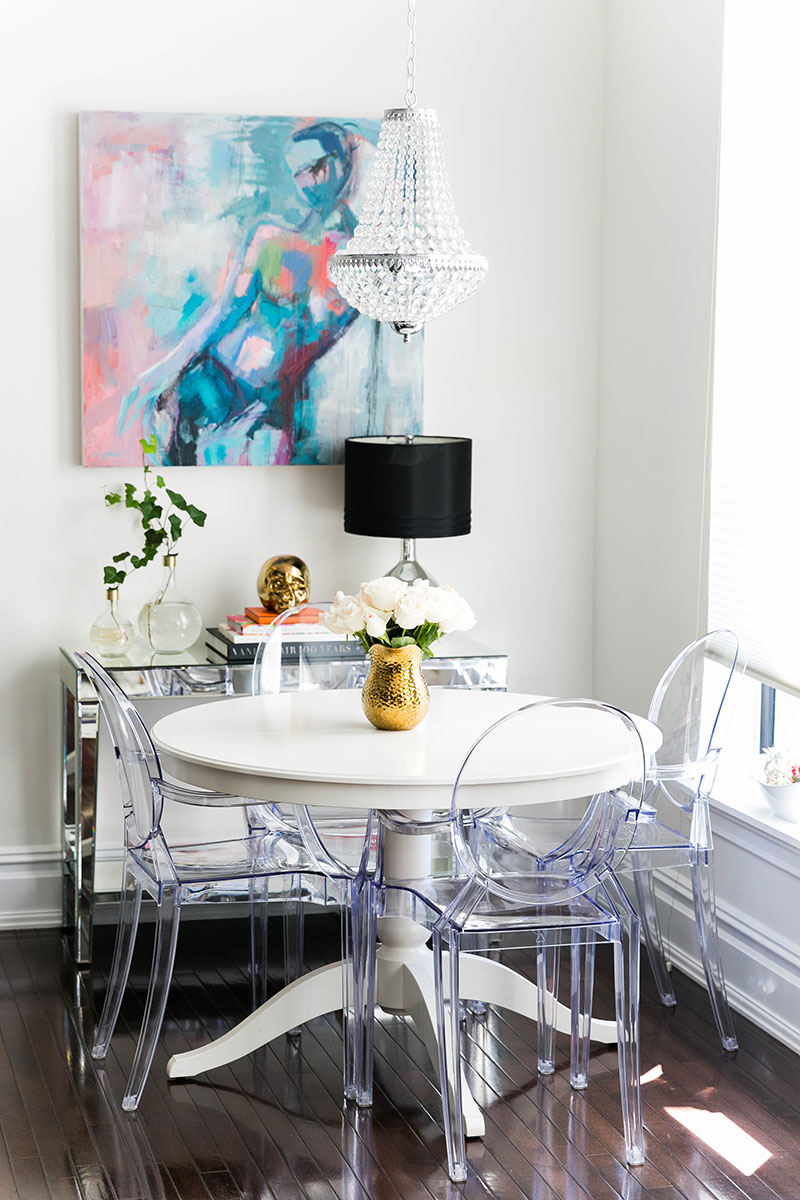 Ghost chairs with white table and blue artwork