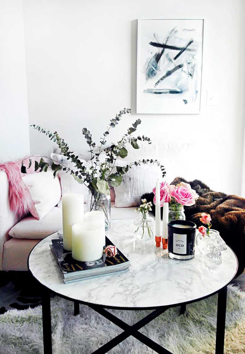 Marble coffee table with black base via The Everygirl