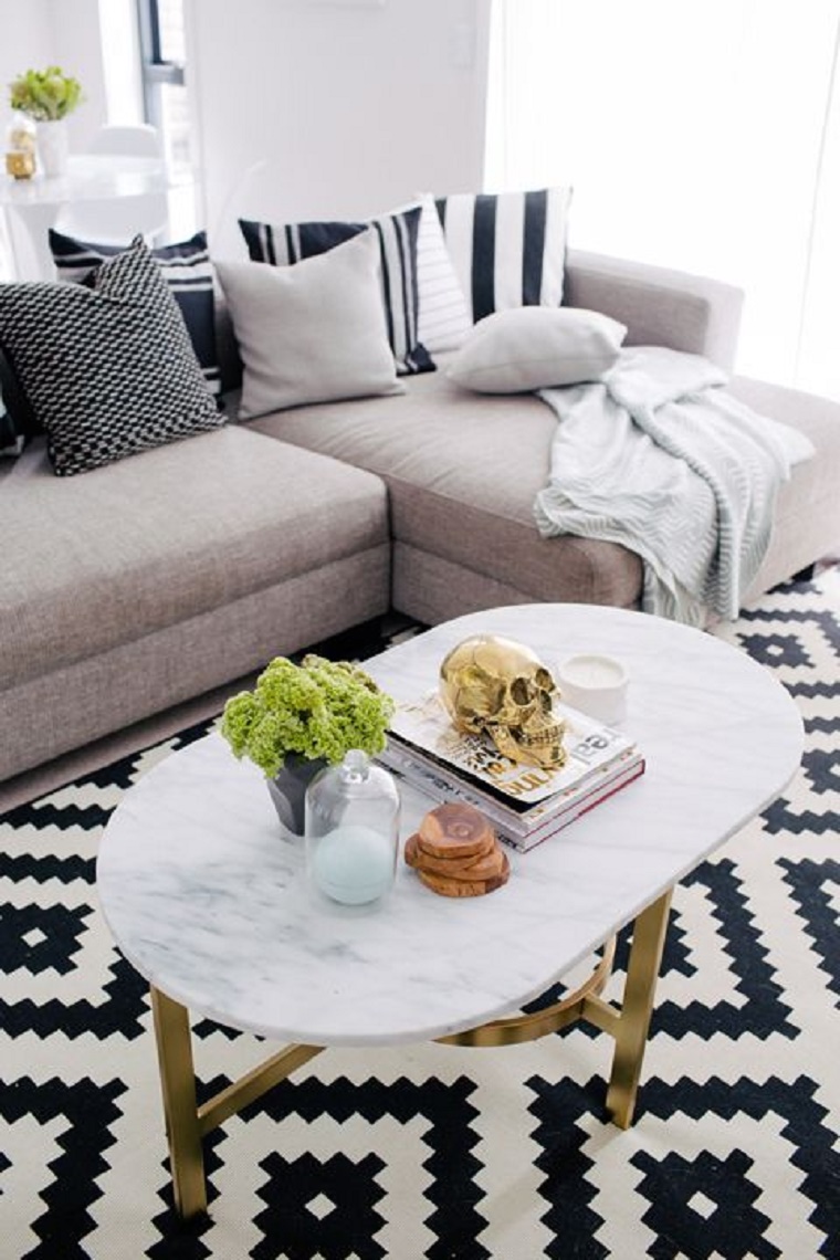Marble coffee table with gold base and black and white rug via West Elm