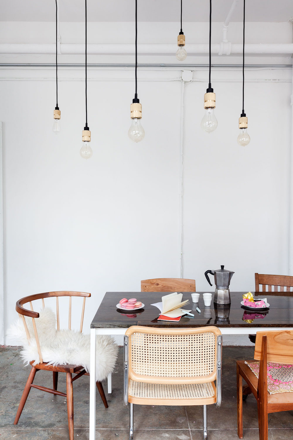 Mismatched dining chairs inside Witness Apt