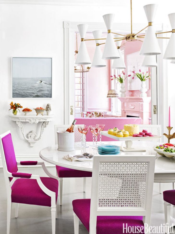 Pink chairs in white dining room via House Beautiful