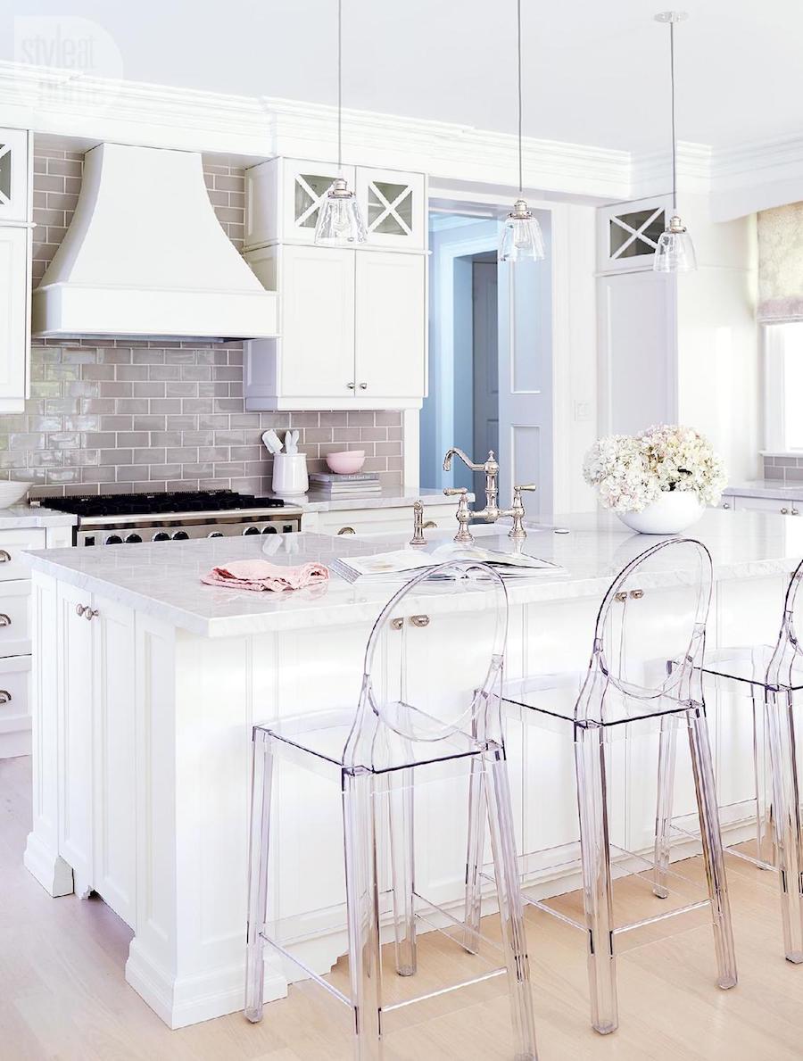 White kitchen with ghost chair bar stools