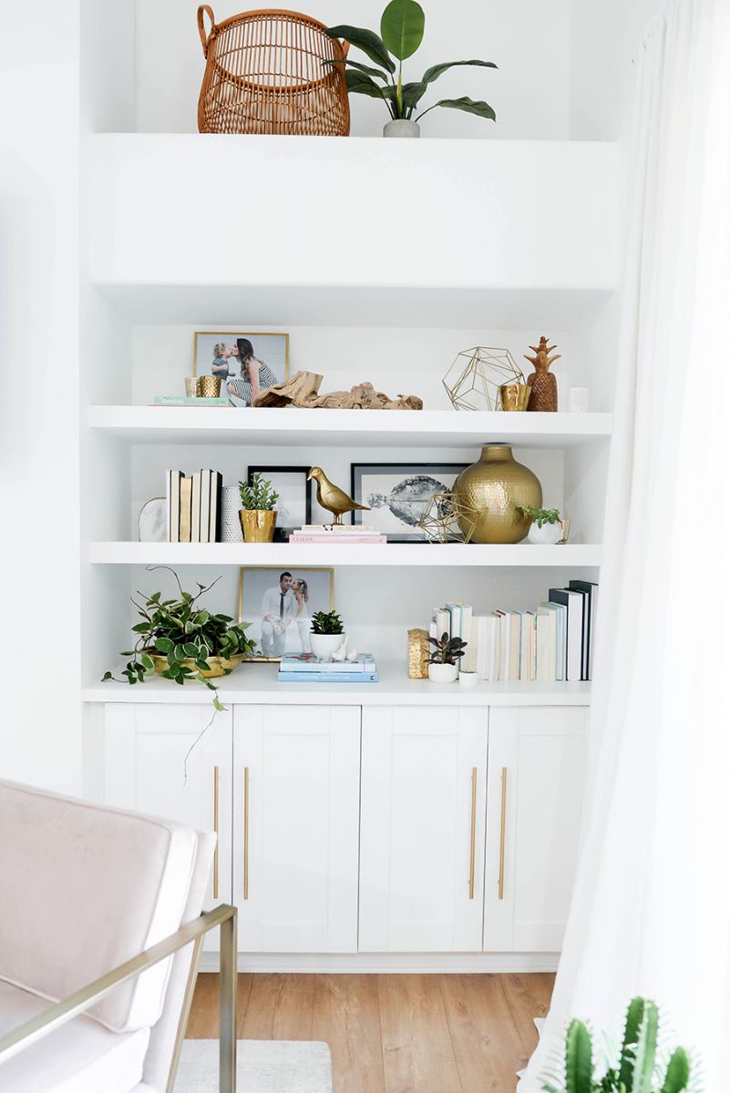 White shelving with gold sculptures