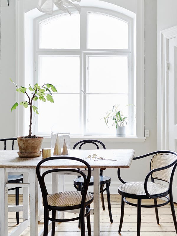 Black bentwood chairs with rattan seats via Stadshem