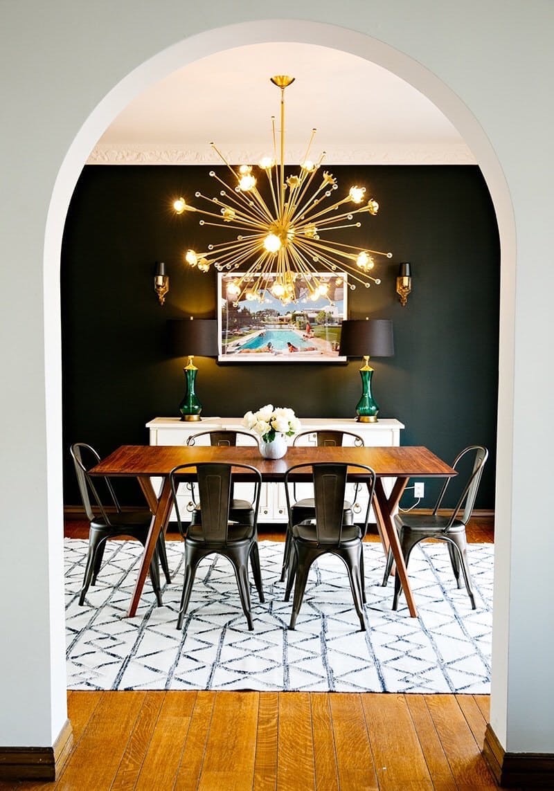 Black wall dining room with gold sputnik chandelier