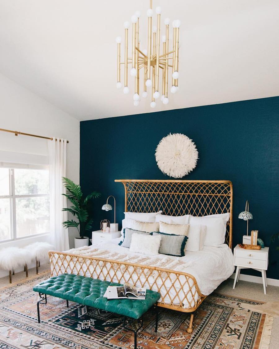 Bold teal accent wall in the bedroom